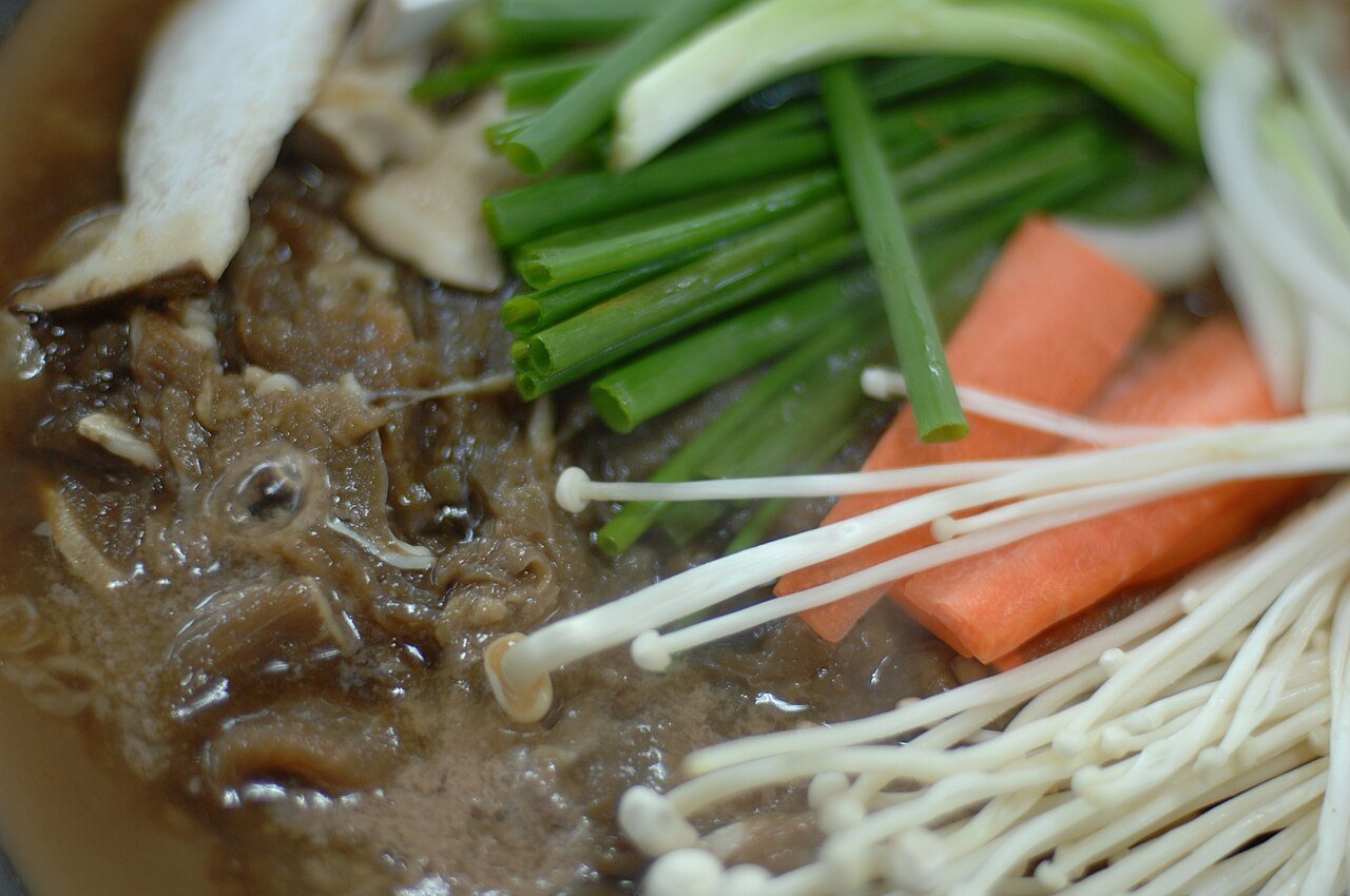 Sliced carrots, scallions, and mushrooms arranged for bulgogi preparation