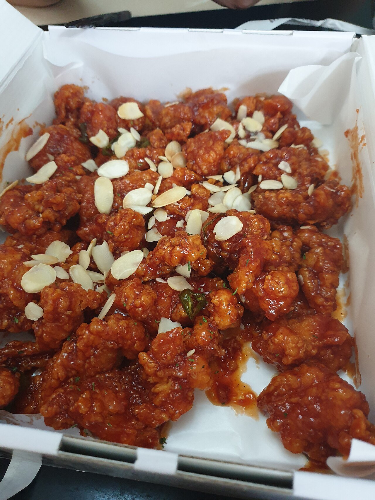 A market-style tray of dakgangjeong from Manseok Dakgangjeong, pieces piled high and glazed