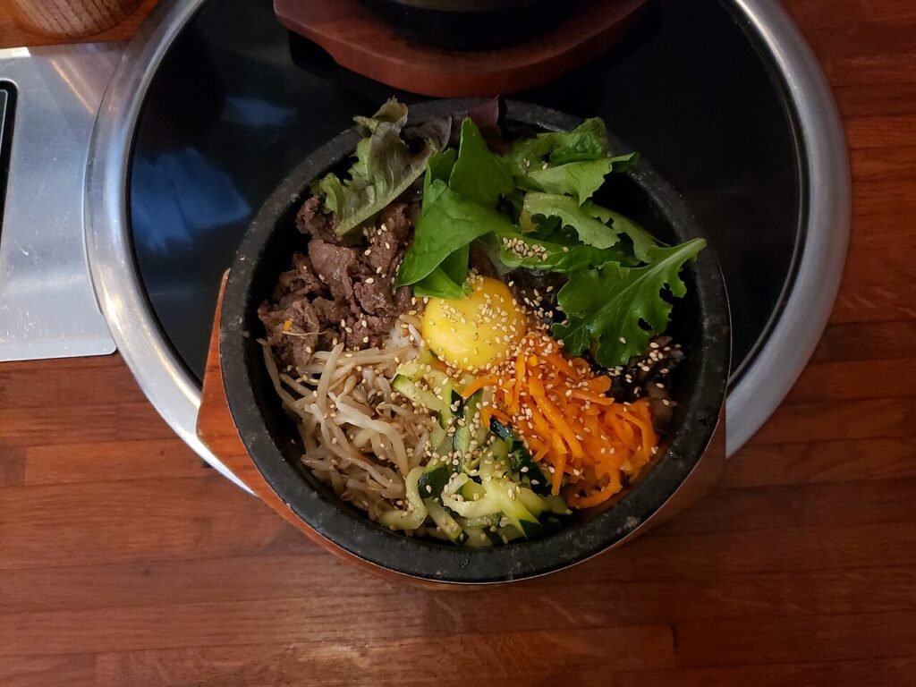 Dolsot bibimbap with beef bulgogi served sizzling in a dark stone bowl