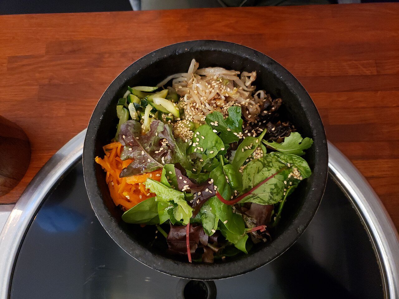 A vegan version of dolsot bibimbap in a stone bowl, without egg or meat