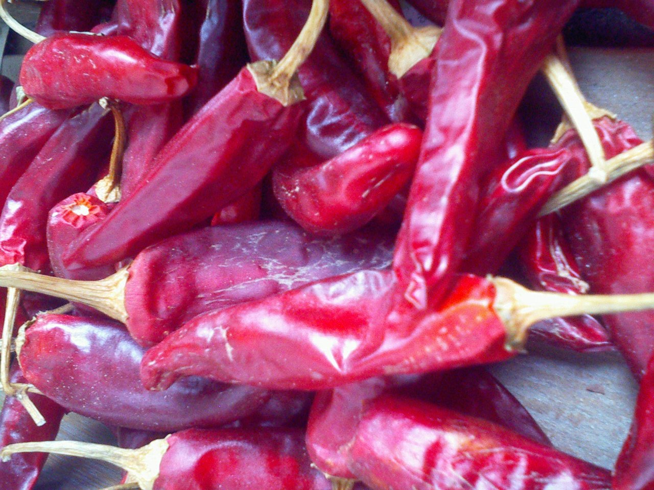 Red Korean chili peppers spread out to dry in the sun