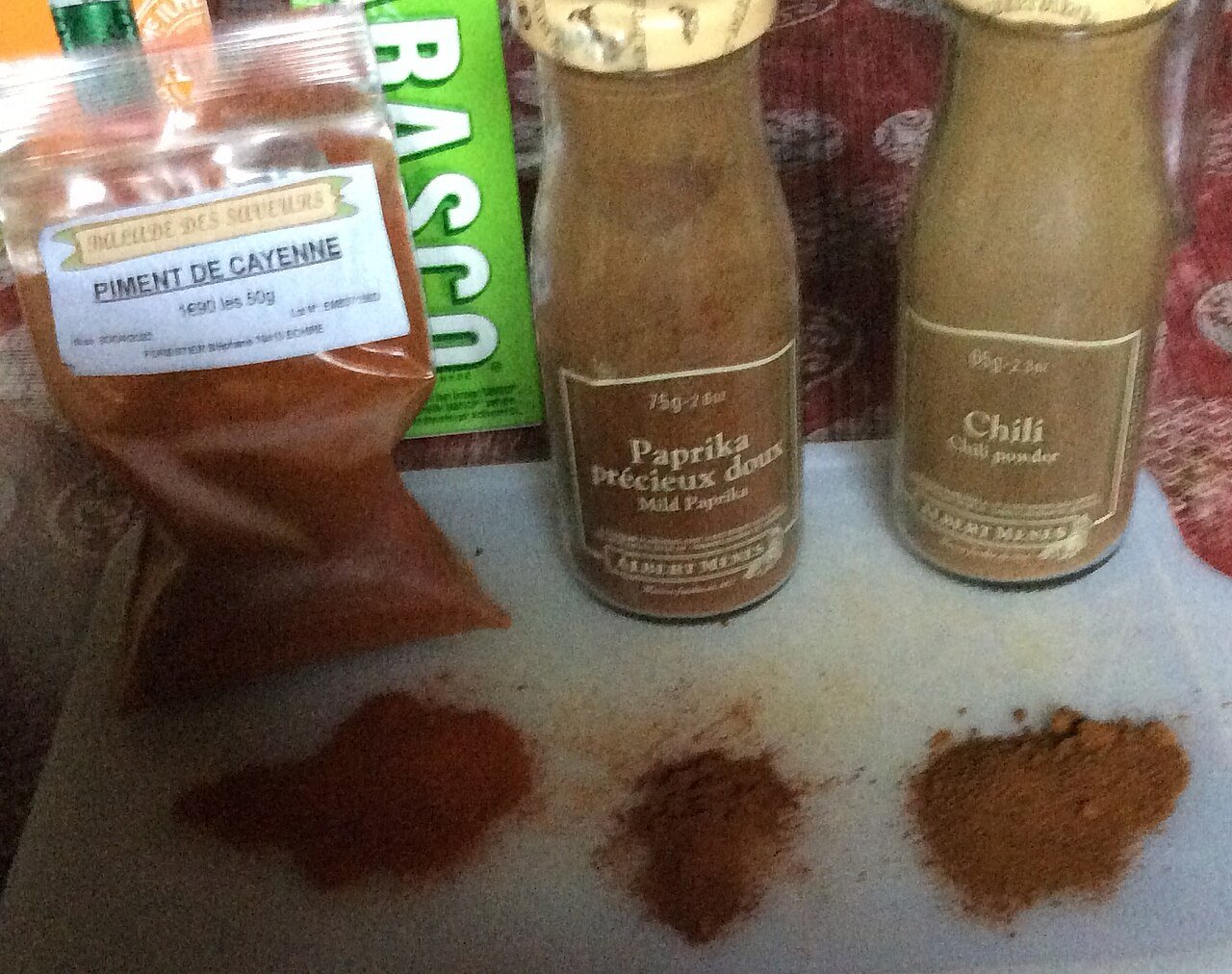 Cayenne pepper, sweet paprika and other ground chilies in small dishes