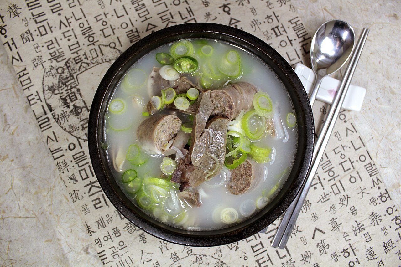 A bowl of haejangguk, Korean hangover soup, with napa cabbage in a beef broth
