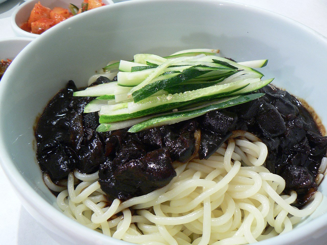 Jjajangmyeon served unmixed, with the black bean sauce sitting on top of the noodles