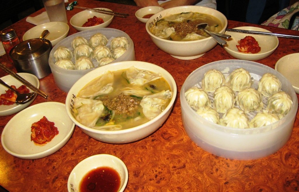 Kalguksu served alongside mandu dumplings, a common restaurant pairing
