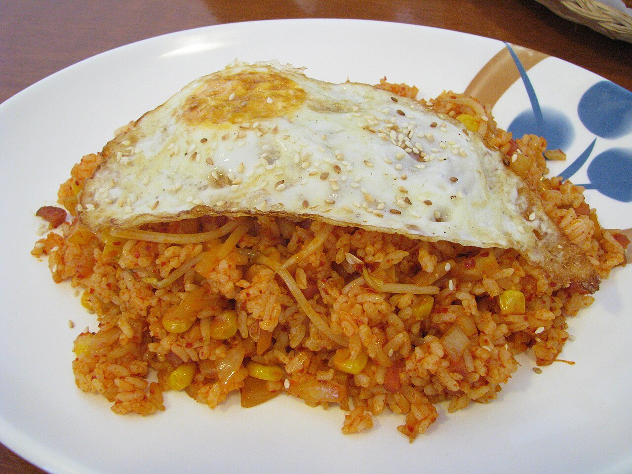 A plate of red-tinted kimchi fried rice, Korean kimchi bokkeumbap