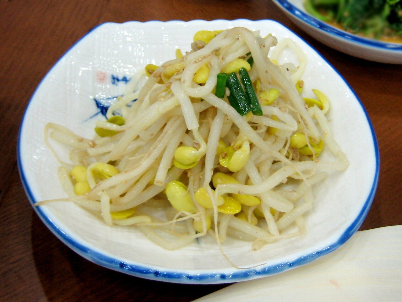 A small plated portion of seasoned soybean sprouts