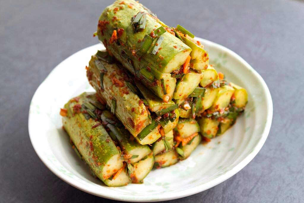 Sliced cucumber kimchi, oi sobagi, stuffed with red chili filling on a small plate