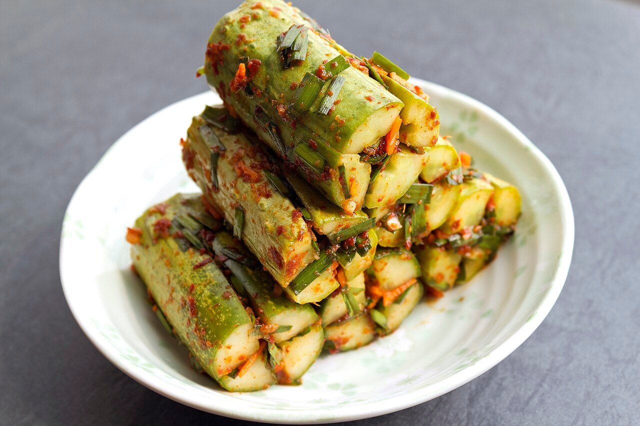 Sliced cucumber kimchi, oi sobagi, stuffed with red chili filling on a small plate