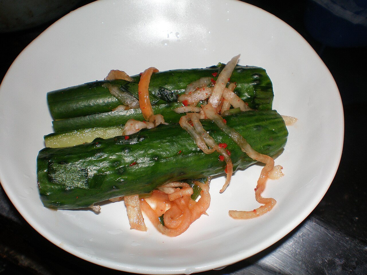 Whole cucumbers slit and stuffed with chili and vegetable filling before fermenting