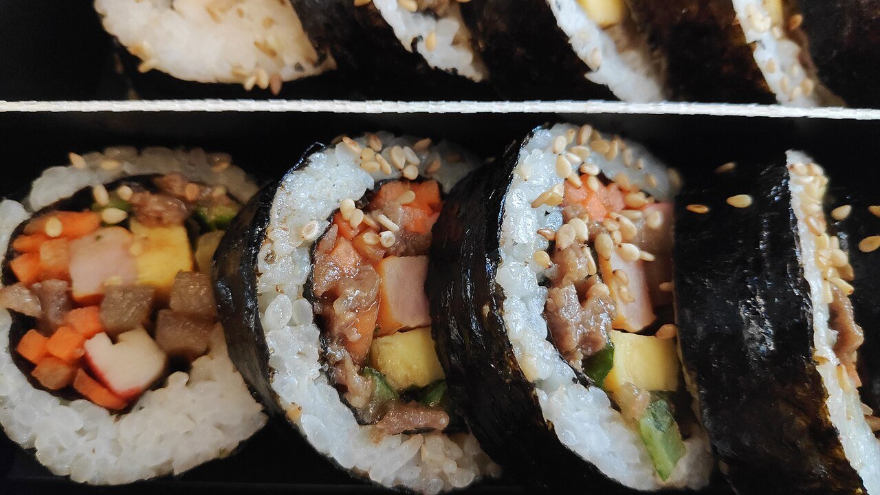 A packaged Korean train lunch box with gimbap and side dishes