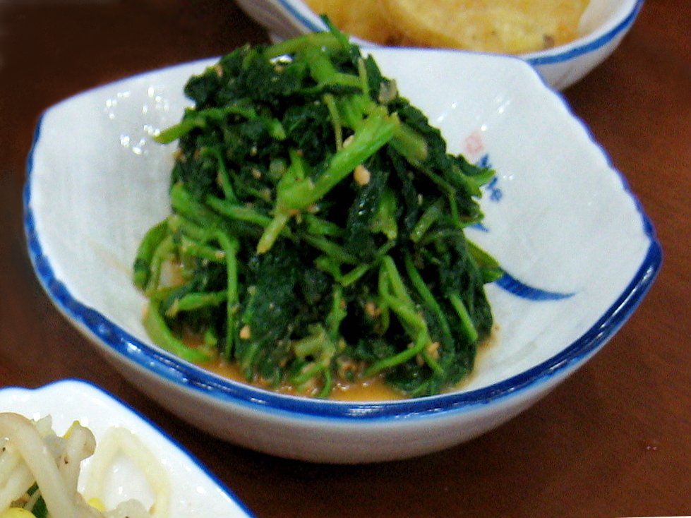 A small plated portion of glossy seasoned spinach namul