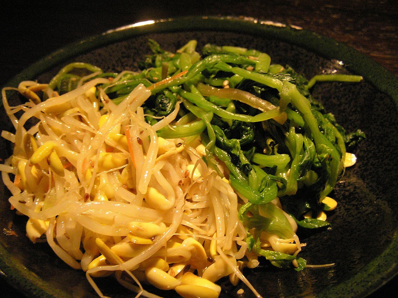Bean sprout namul and spinach namul served side by side as two banchan