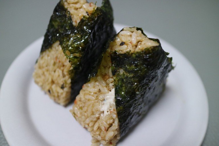 A triangular samgak kimbap rice ball wrapped in seaweed, the Korean convenience-store snack