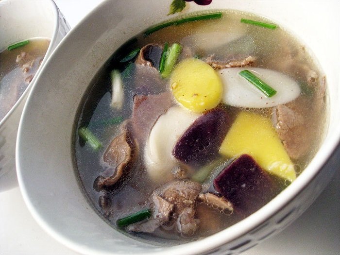 Tteokguk made with five-colored rice cake slices in a clear beef broth