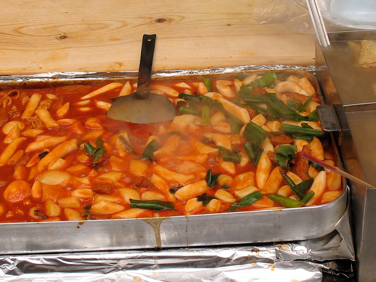 Korean rice cakes in a thick glossy red gochujang sauce